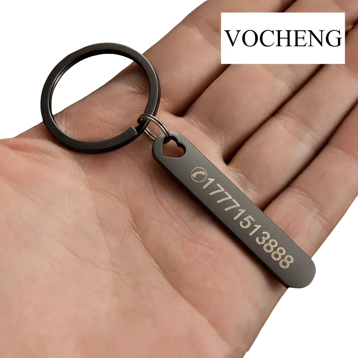 Black metal custom phone number keychain with heart-shaped cutout and laser engraved phone number detail