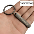 Black metal keychain with rectangular laser engraved tag displaying a phone number and logo for customization