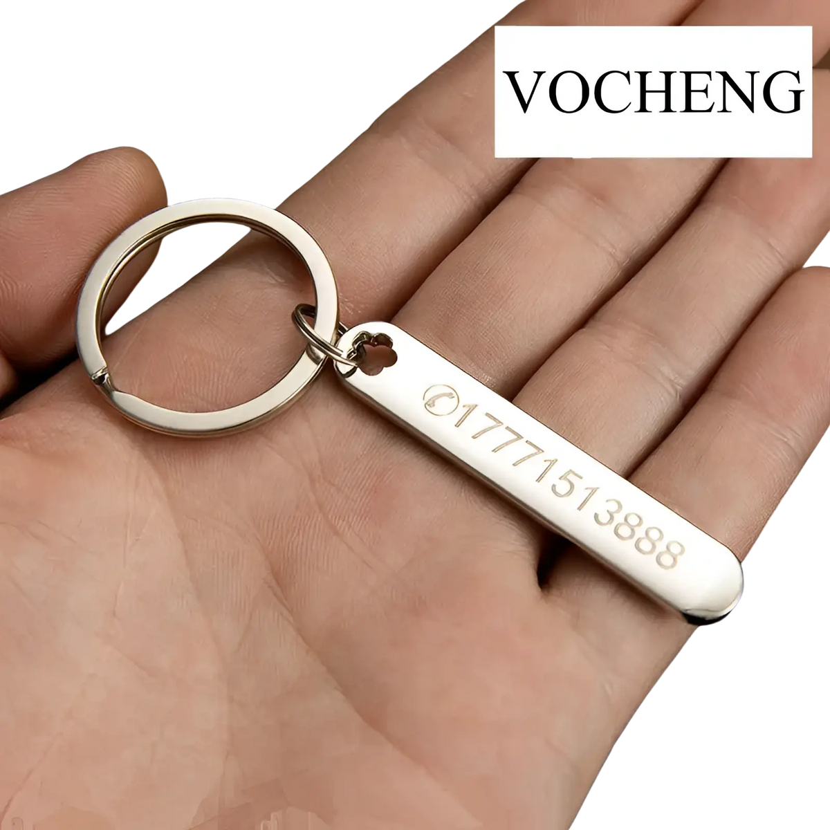 Silver metallic custom phone number keychain with laser engraved rectangular tag and small heart cutout