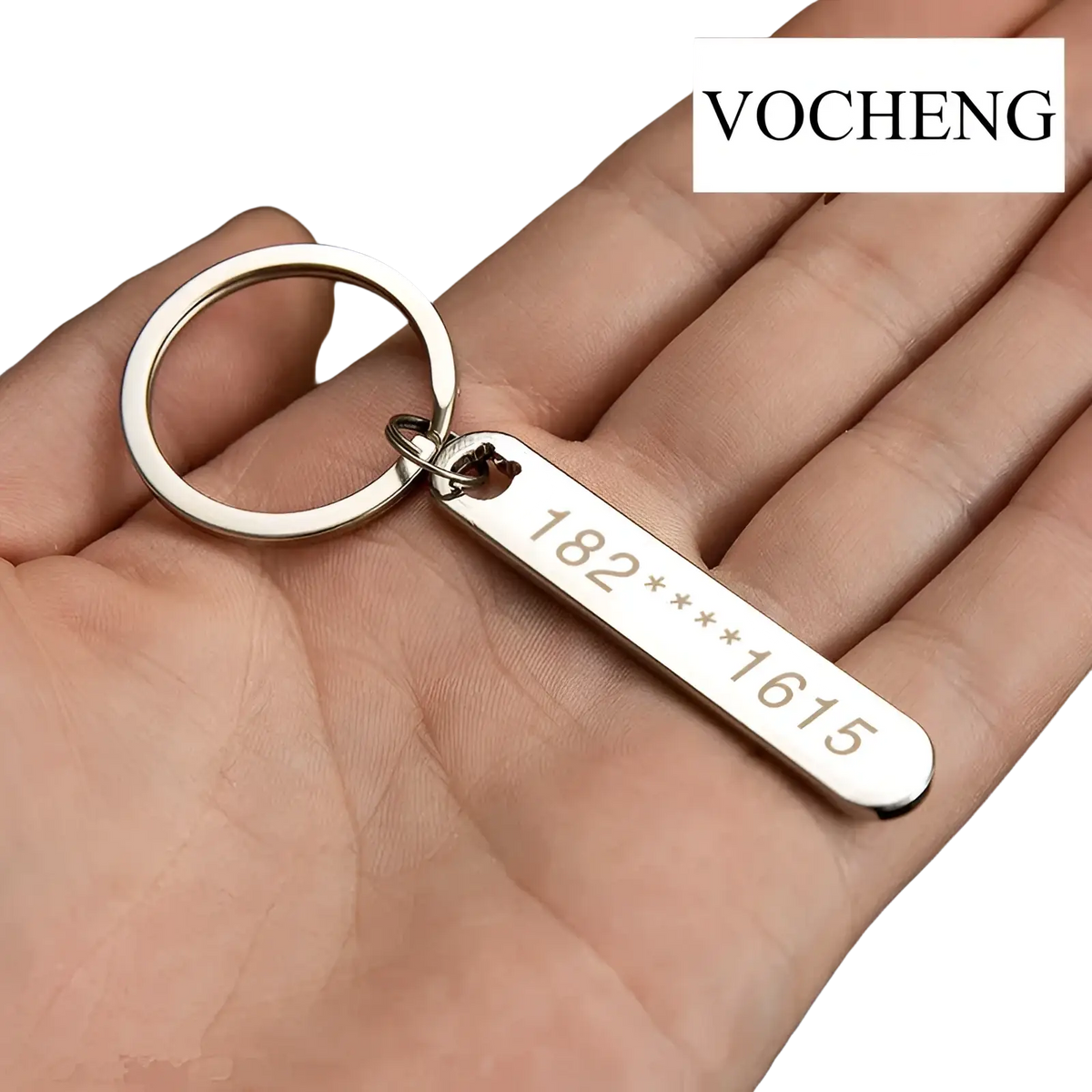 Silver rectangular metal keychain with laser engraved phone number and circular ring branded vocheng for custom use