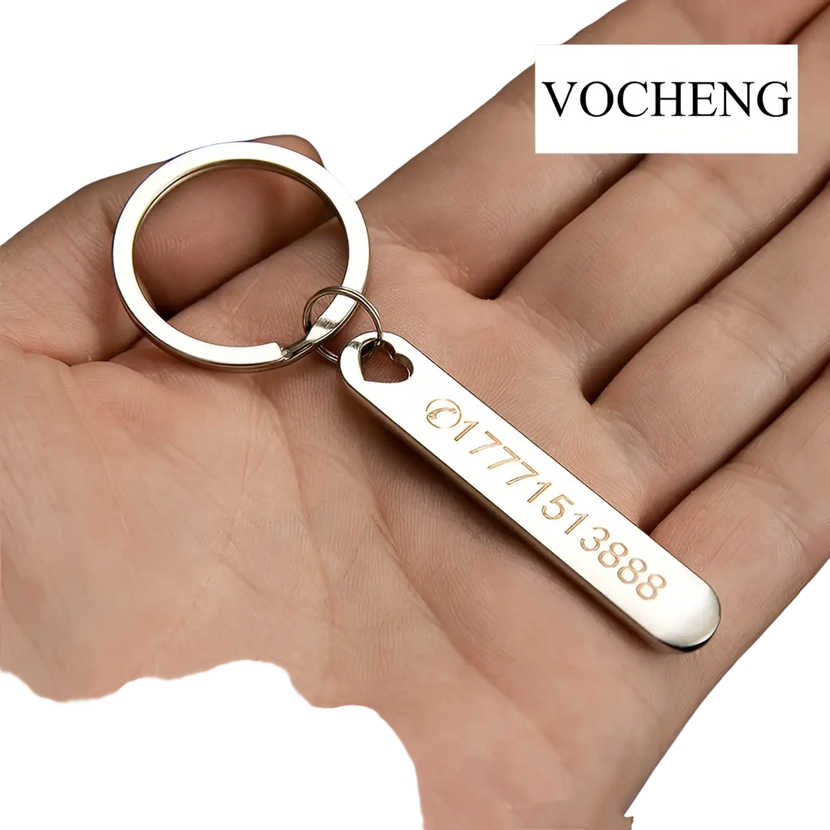 Silver metallic custom phone number keychain with heart-shaped cutout and laser engraved metal tag