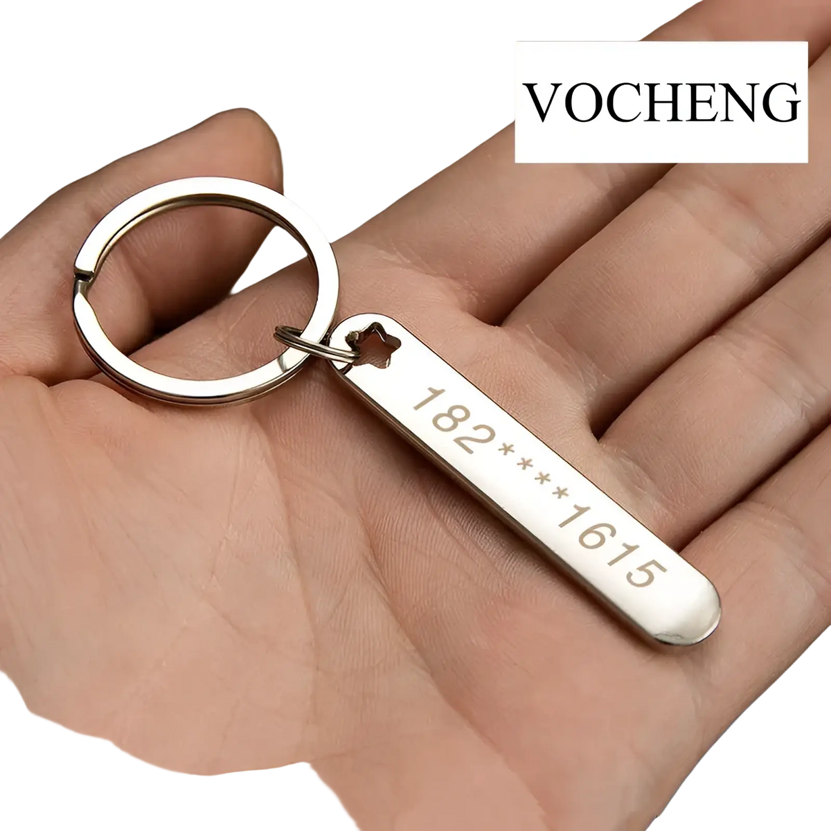 Silver metal custom phone number keychain with rectangular laser engraved tag and star-shaped cutout at the top