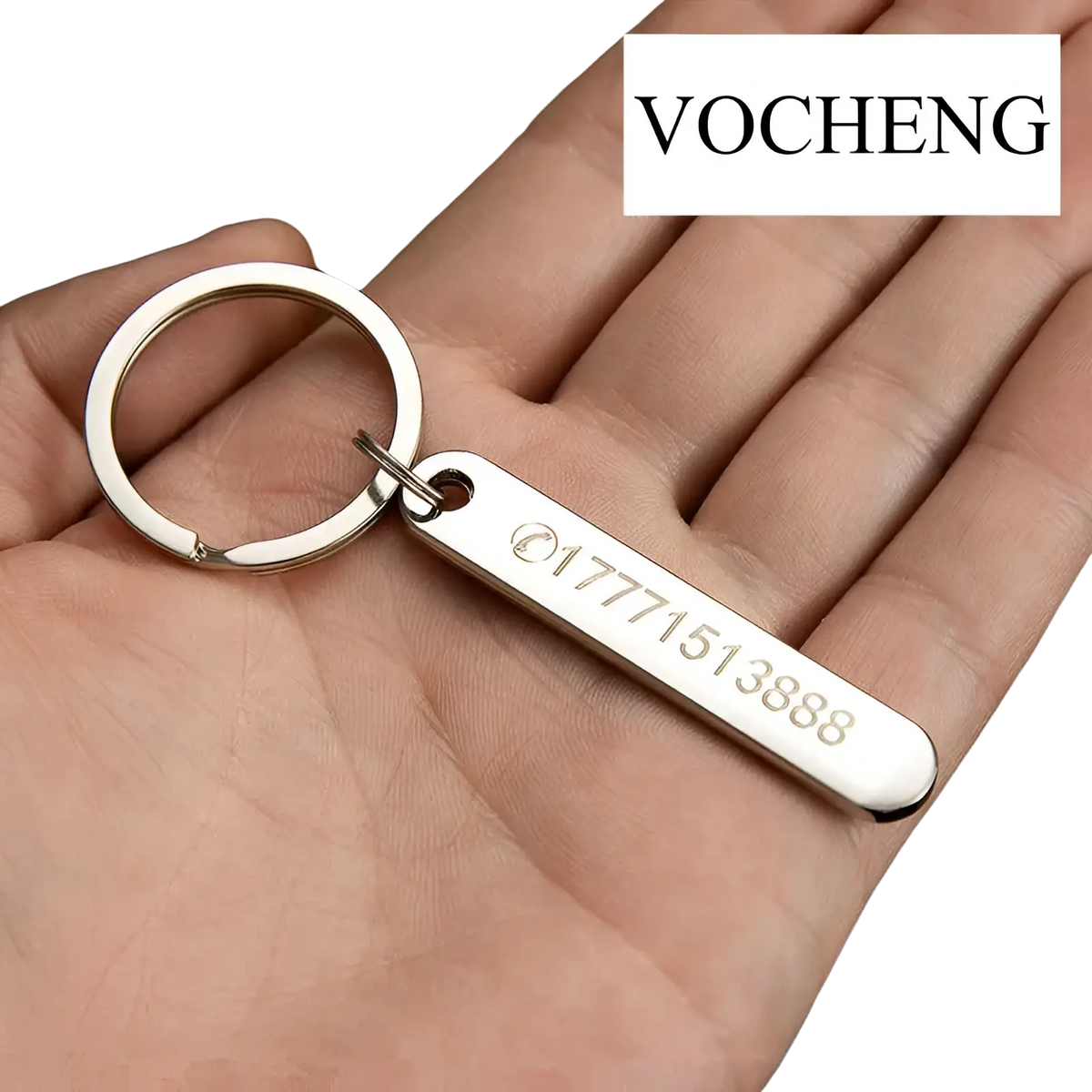 Silver rectangular metal keychain laser engraved with phone number and circular vocheng logo for custom use