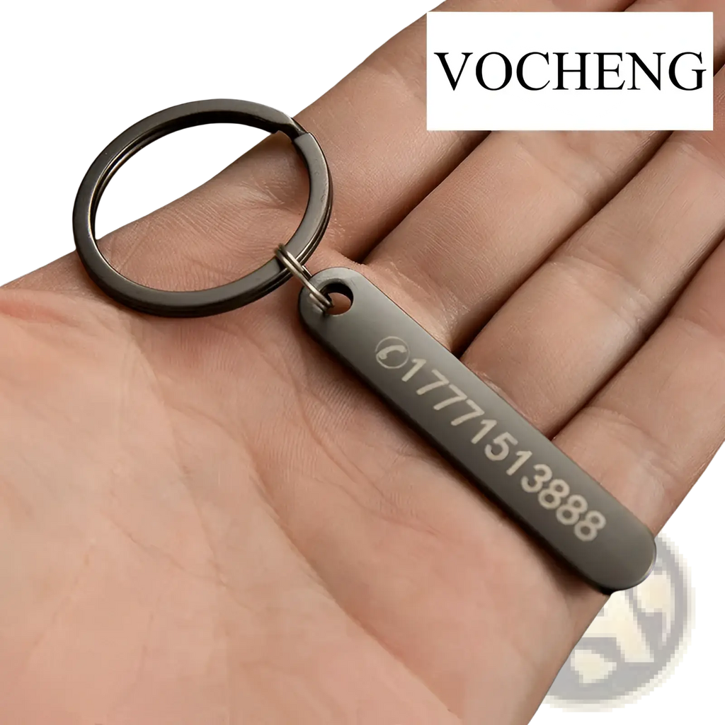 Black metal keychain with rectangular laser engraved tag displaying a phone number and logo for customization