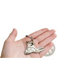 Silver-colored custom photo engraved stainless steel keychain pendant shaped like a reclining akita dog