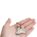 Silver-colored custom photo engraved stainless steel keychain pendant shaped like a reclining akita dog