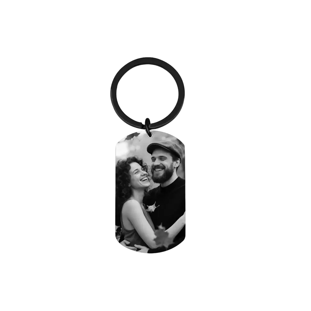 Black metal dog tag keychain with a black-and-white photo of a smiling couple for custom photo keychain for couples