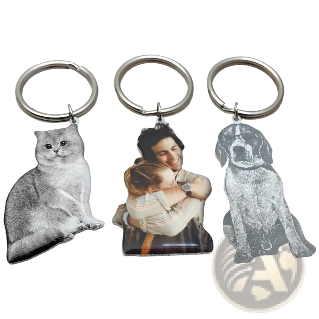 Three personalized photo keychains with engraved images of a cat, a couple embracing, and a dog on metal keyrings