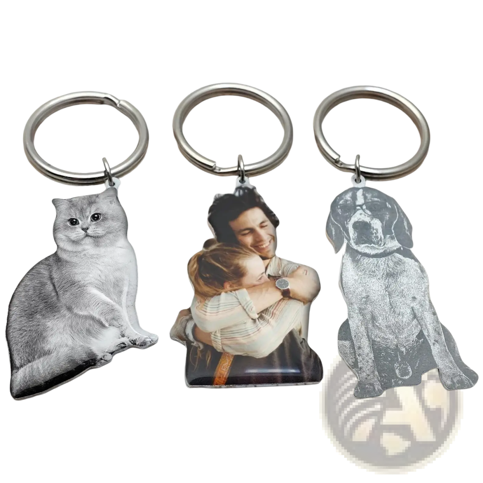 Three personalized photo keychains with engraved images of a cat, a couple embracing, and a dog on metal keyrings