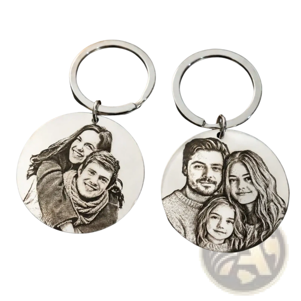 Two silver stainless steel round keychains engraved with detailed black and white family portraits
