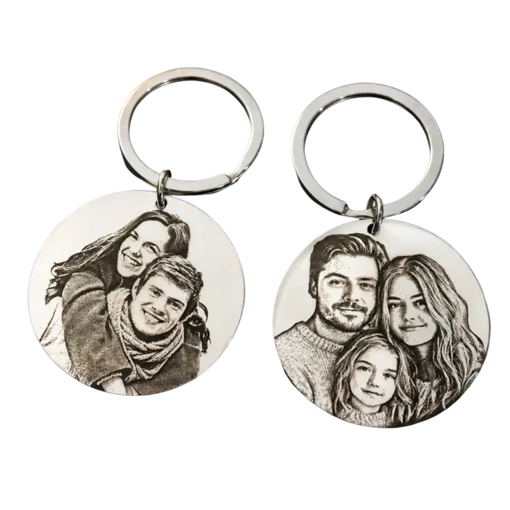 Two silver stainless steel round keychains engraved with detailed black and white family portraits