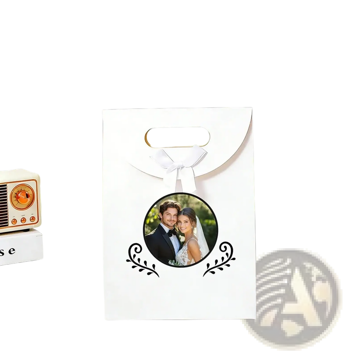 White custom photo wedding favor bag with gold handles and black ornamental leaf designs featuring couple photo