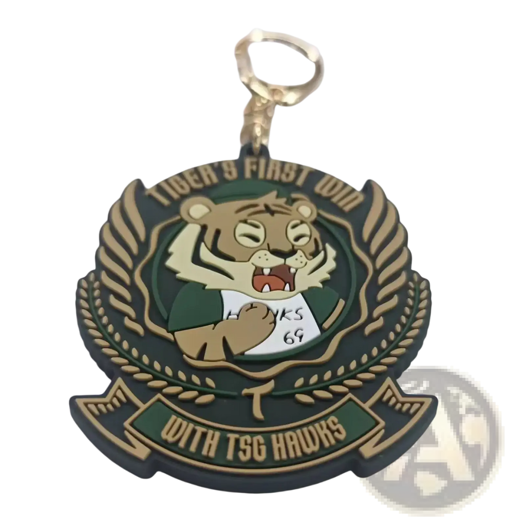 Green and gold custom PVC rubber keychain with cartoon tiger mascot in green jersey and laurel wreath design