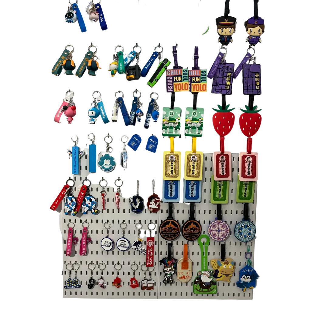 A colorful collection of custom pvc keychains with personalized rubber logos featuring cartoon characters and branded designs