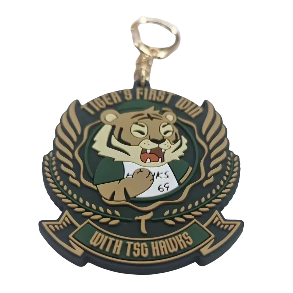 Green and gold custom PVC rubber keychain with cartoon tiger mascot in green jersey and laurel wreath design