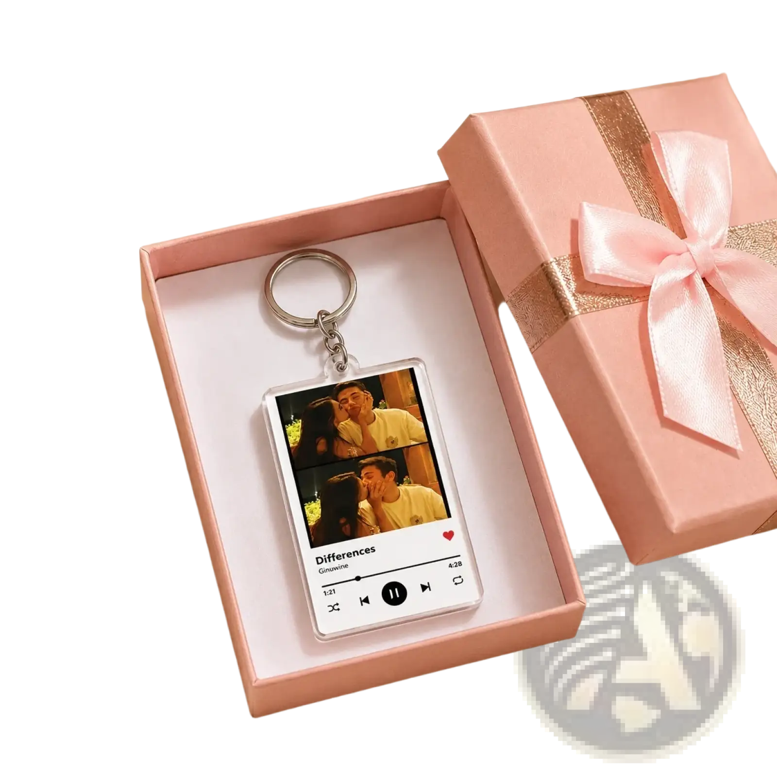 A clear rectangular acrylic custom Spotify music player keychain with couple photos and song details in a pink gift box