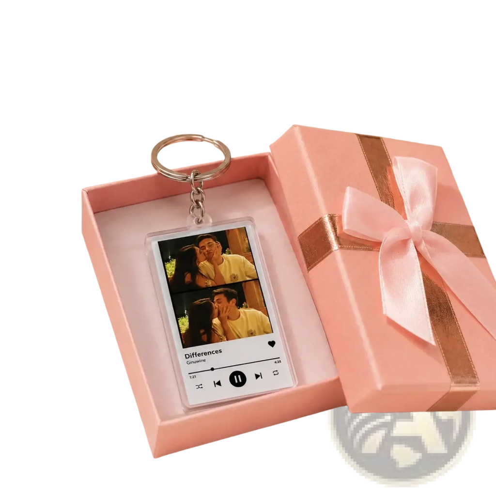 Pink gift box with satin ribbon open to reveal custom acrylic spotify music player keychain featuring couple photos