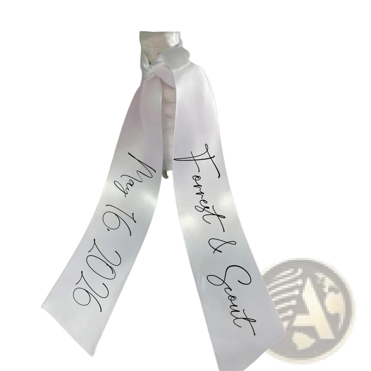 Custom wedding bouquet ribbon made of white satin with black cursive script featuring personal names and date