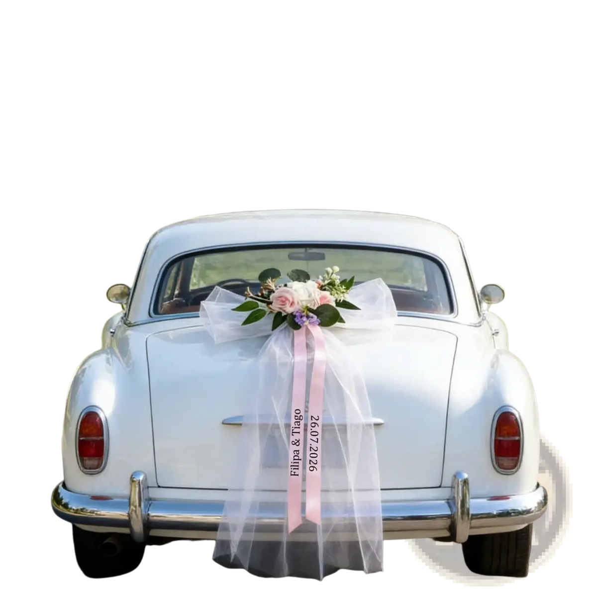 White vintage wedding car rear adorned with custom floral garland and pink ribbon set for bridal decoration