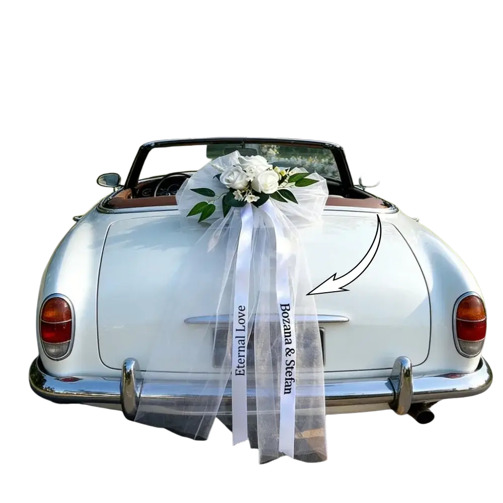 Custom wedding car floral garland and ribbon set with white satin ribbon bow and fresh white roses on convertible rear