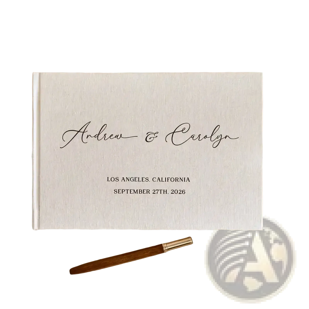 Cream-colored linen-bound custom wedding guest book with black cursive engraving and matching wooden pen photo album