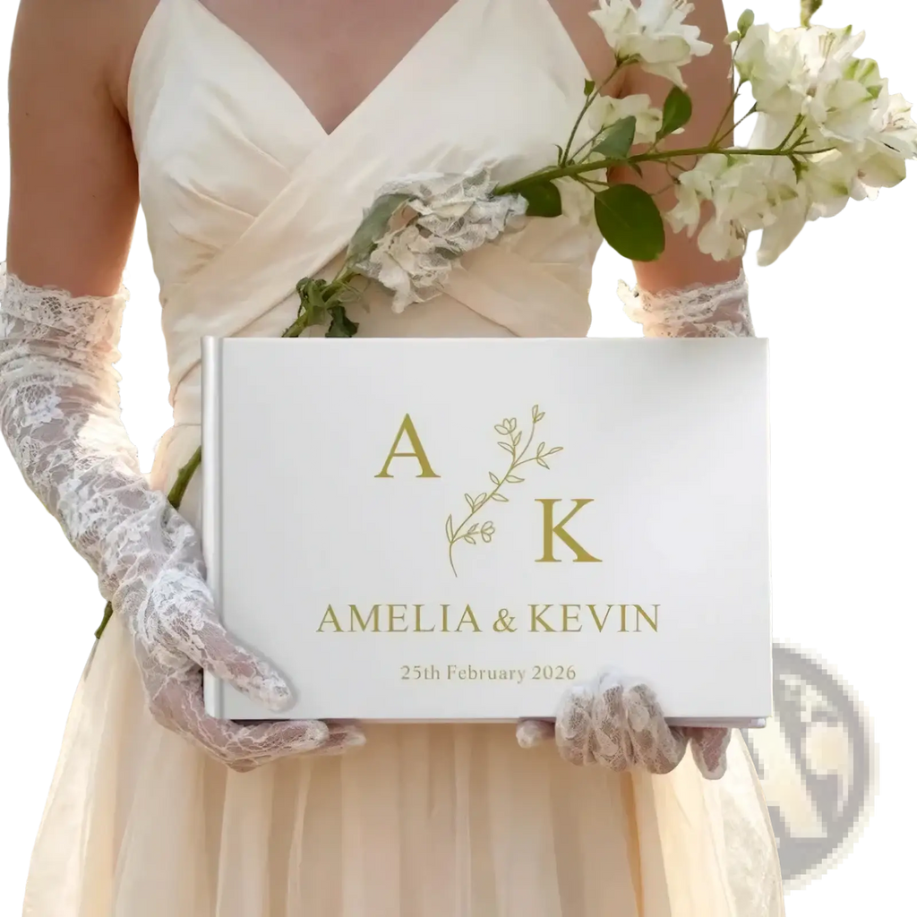 Custom wedding guest book in white with gold foil lettering and a delicate floral design between initials a and k