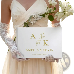 Custom wedding guest book in white with gold foil lettering and a delicate floral design between initials a and k