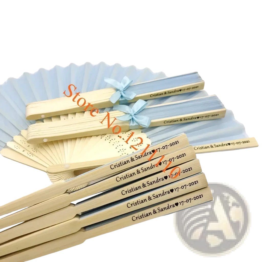 Custom wedding hand fans in light blue and cream with engraved names and dates tied with matching ribbons