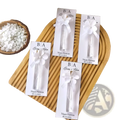 Custom white floral-themed wedding perfume favor bottles with personalized gift cards and ribbon ties for elegant presentation