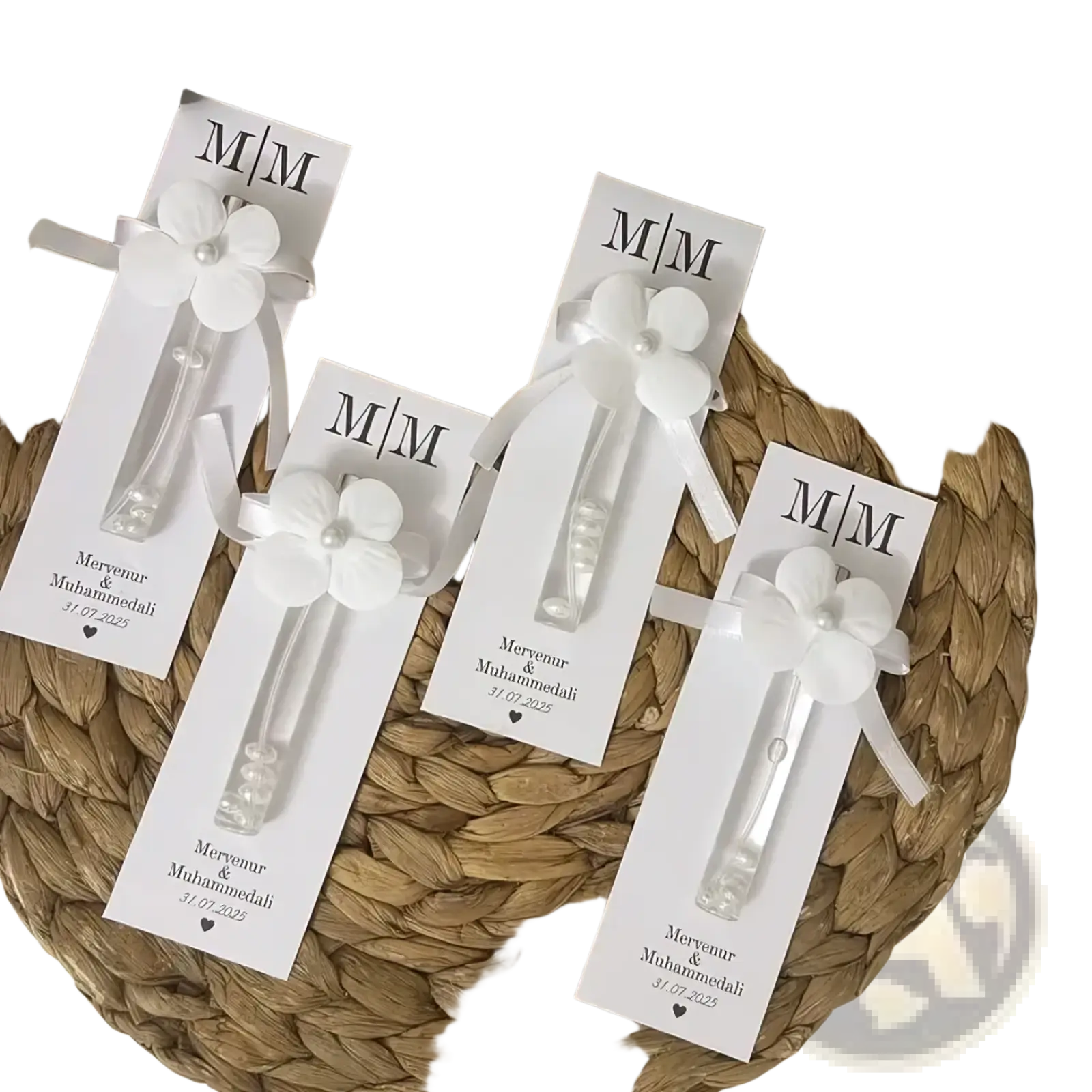 Custom wedding perfume favor bottles with white flower-shaped glass bodies and pearl accents on personalized m/m cards