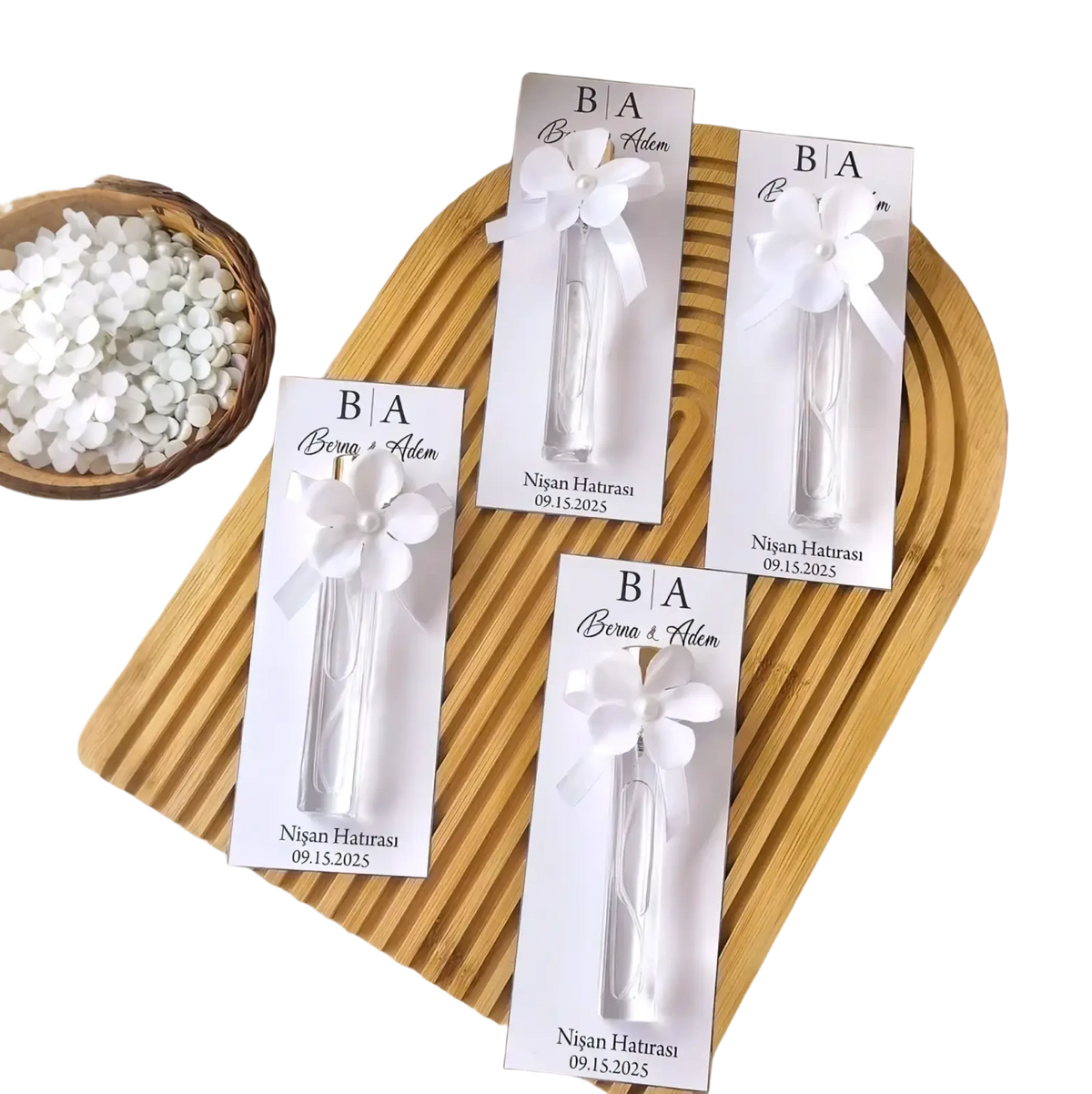 Custom white floral-themed wedding perfume favor bottles with personalized gift cards and ribbon ties for elegant presentation