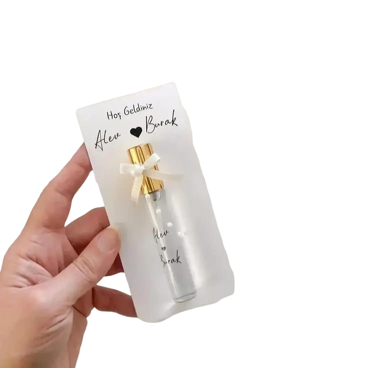 A clear glass custom wedding perfume vial with a gold cap and white ribbon in a personalized gift card