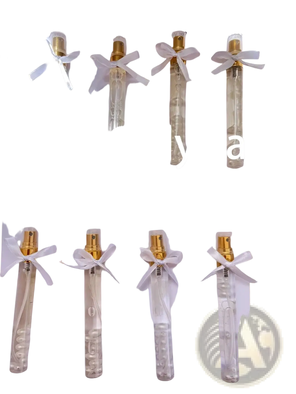 Clear glass custom wedding perfume gift vials with gold spray nozzles and white ribbons tied around the neck