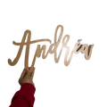 Custom wooden baby name sign in light-colored wood with the name Andrew in flowing cursive for nursery wall decor