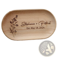 Light brown wooden oval ring dish engraved with floral design personalized with names stephanie patrick and date