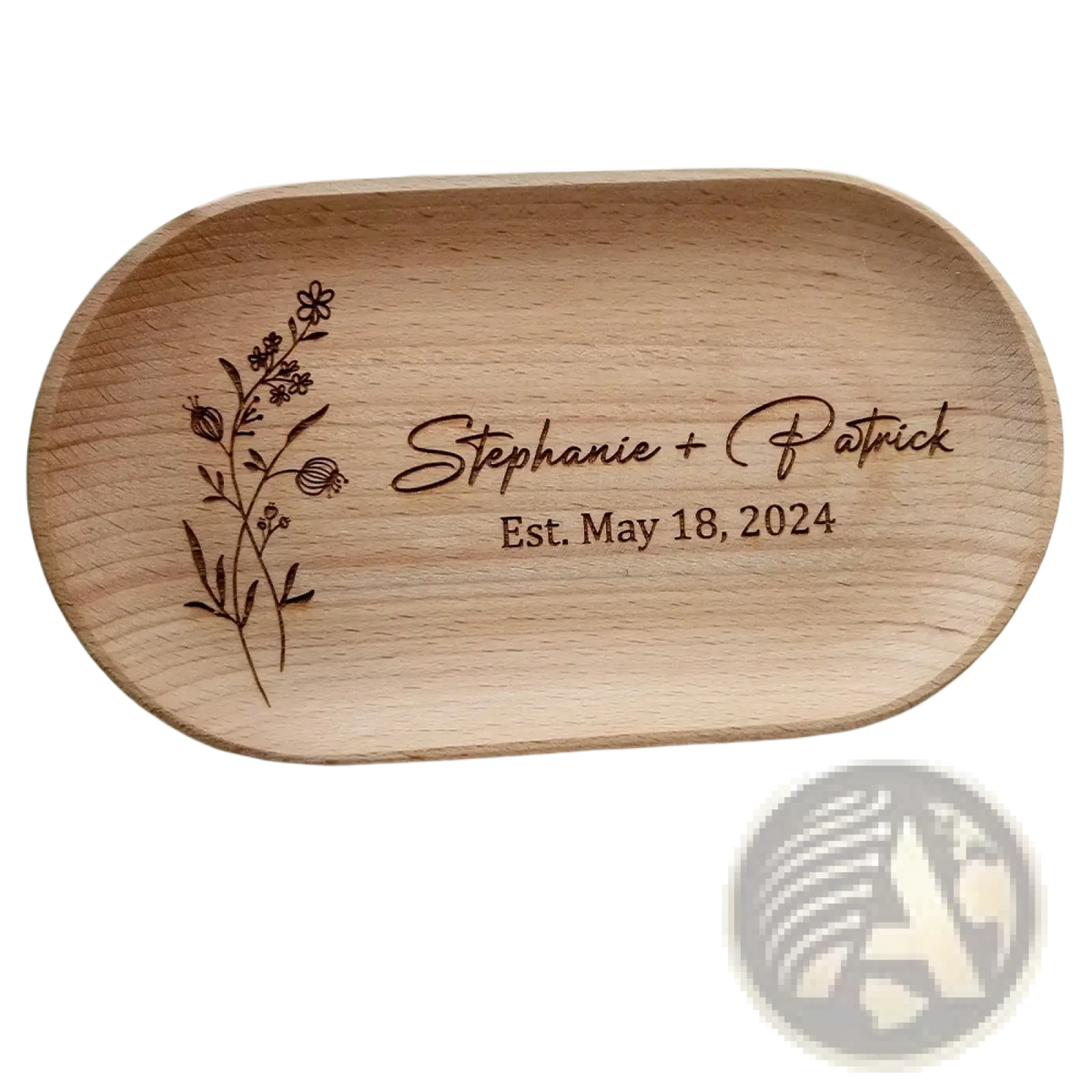 Light brown wooden oval ring dish engraved with floral design personalized with names stephanie patrick and date