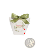 Customizable white paper wedding favor box with sage green satin bow and botanical wreath design with names and date