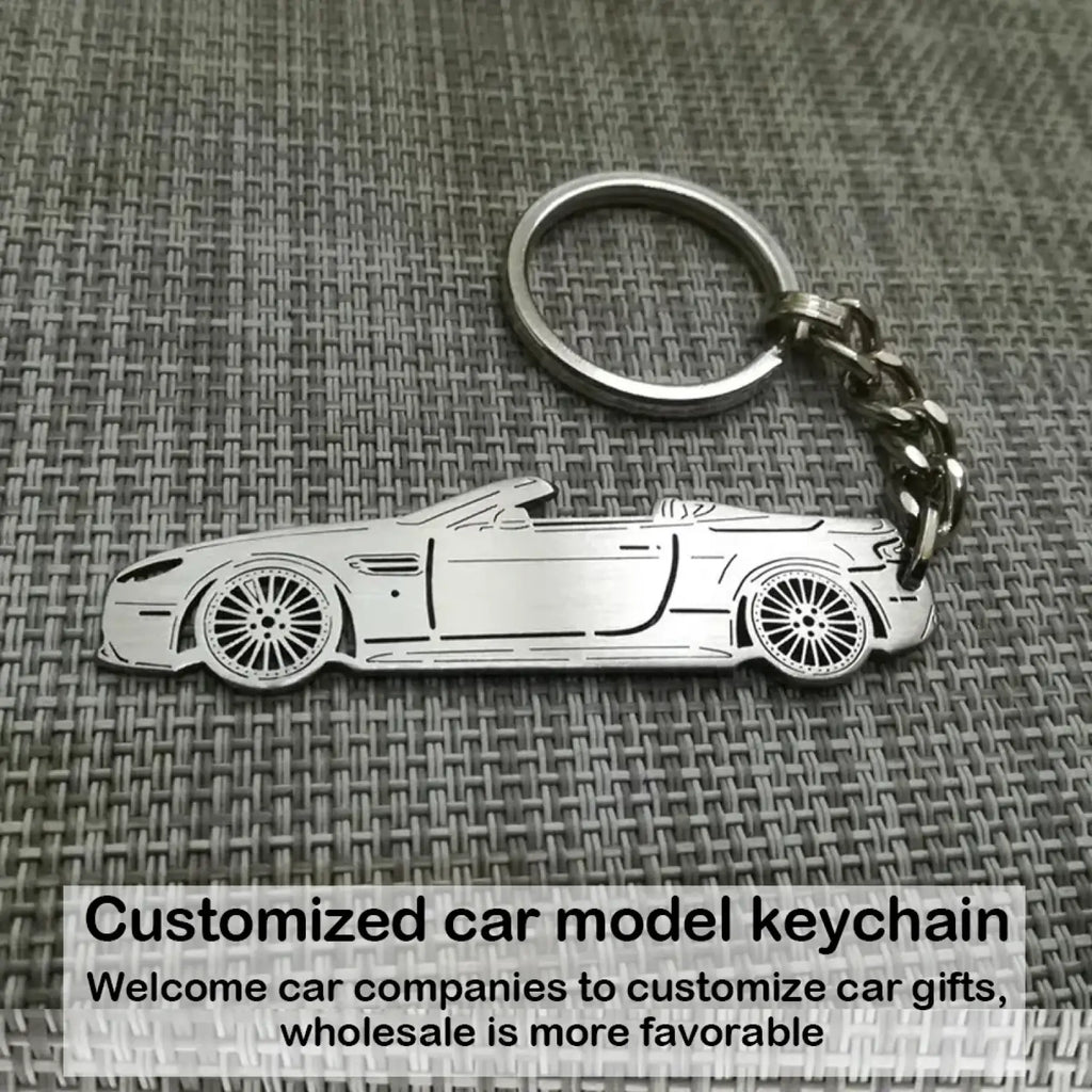 Silver metallic customized car model metal keychain shaped like a convertible sports car with detailed wheels and body lines