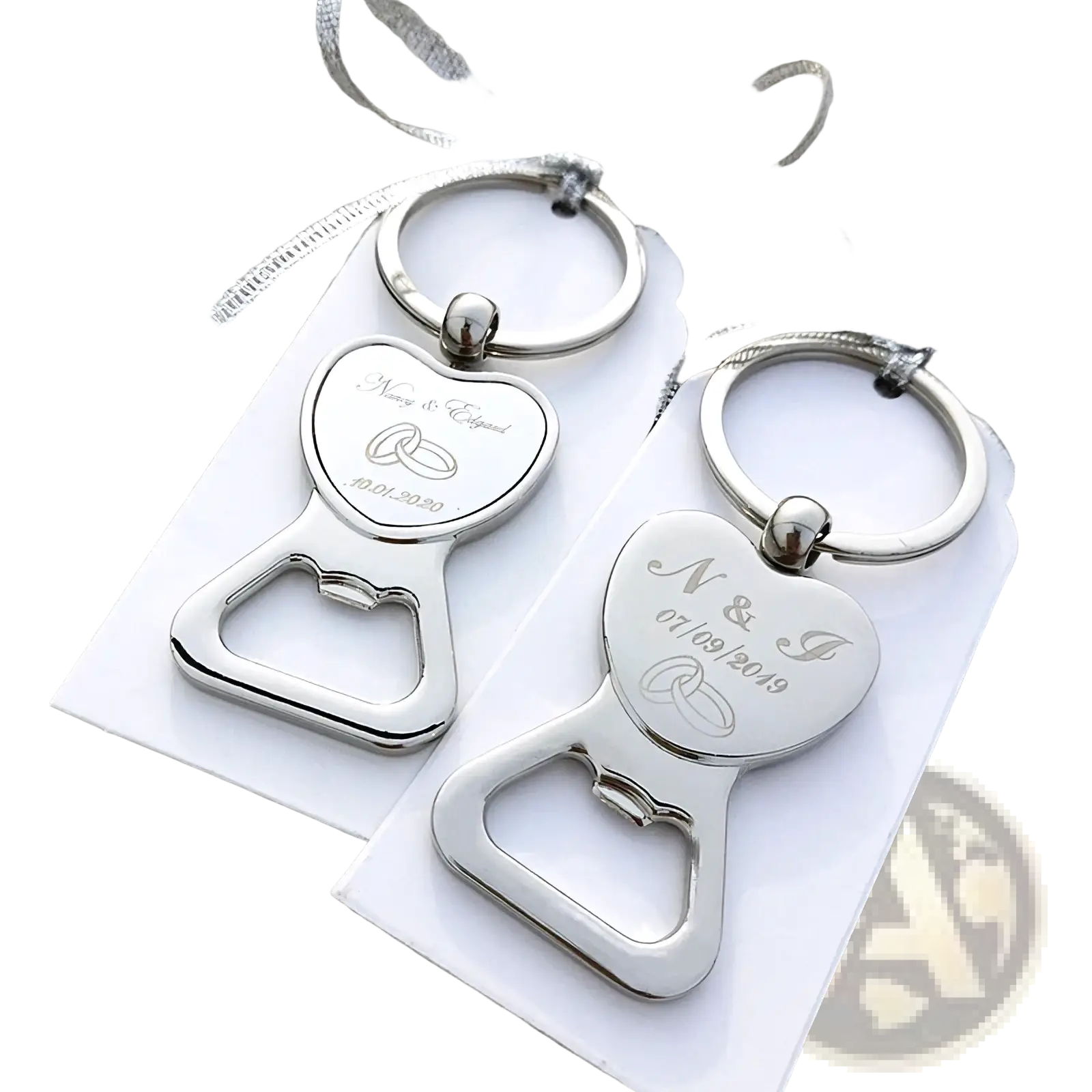 Silver heart-shaped metal bottle openers with engraved wedding details and rings attached to keychains as favors