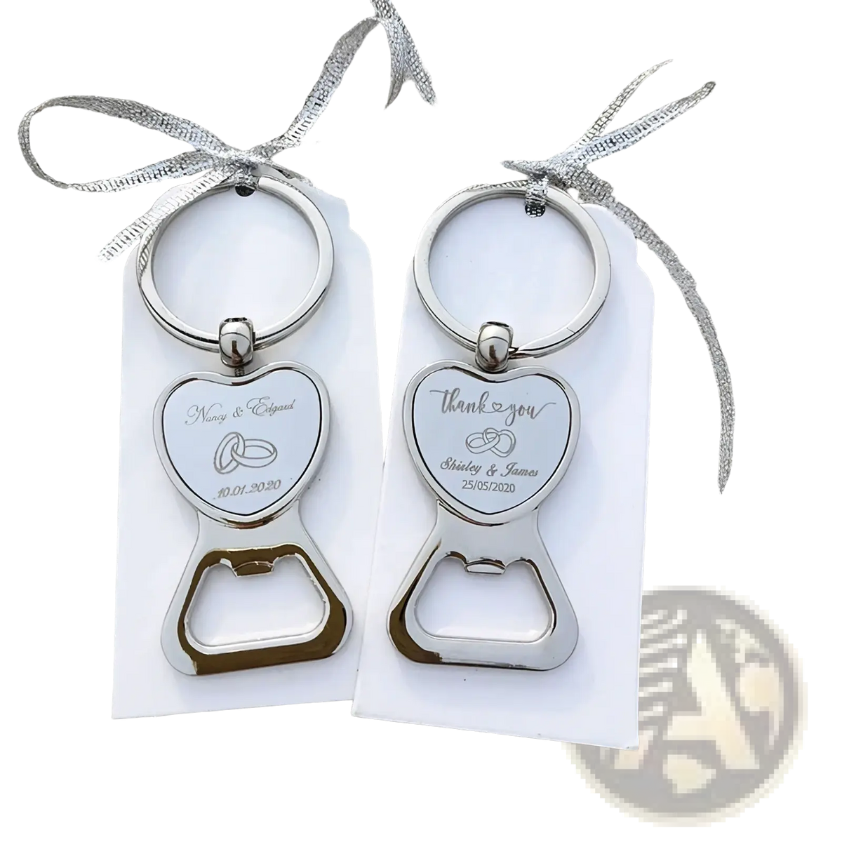 Silver heart-shaped metal bottle opener wedding favors with engraved details and rings attached to white tags with silver ribbon