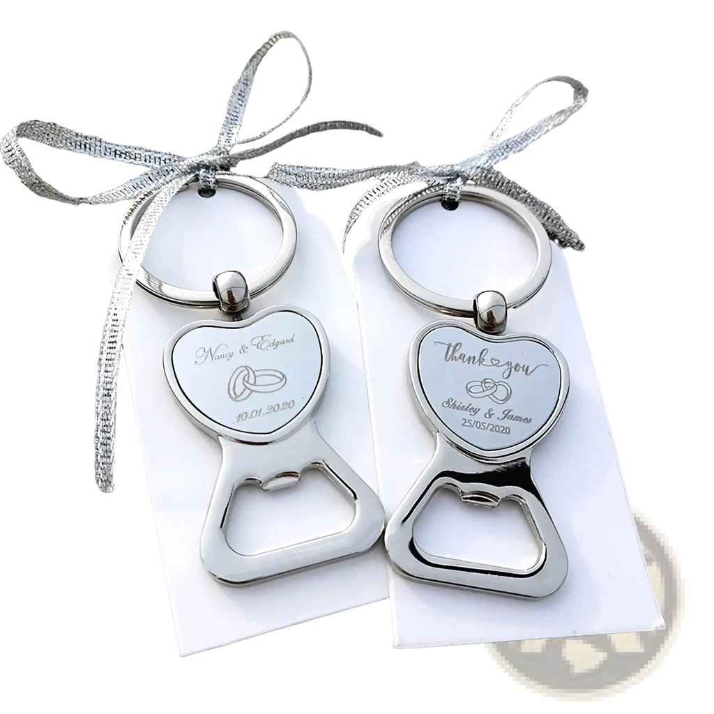 Silver heart-shaped metal bottle openers engraved with wedding details and rings attached to keychains as favors