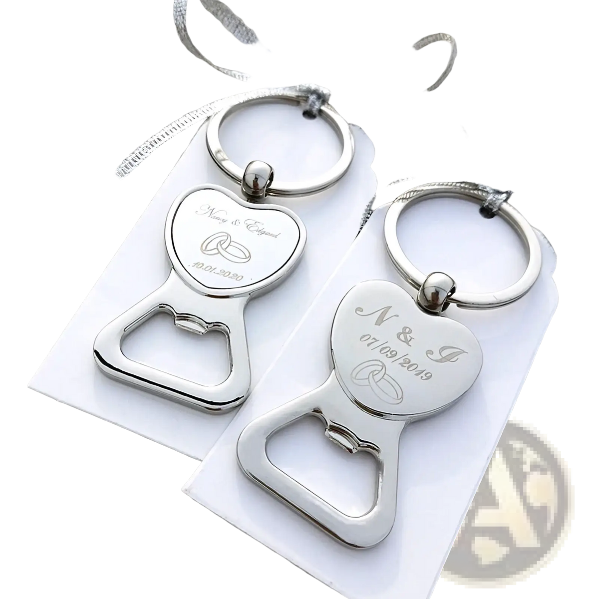 Silver heart-shaped metal bottle openers with engraved wedding details and rings attached to keychains for favors