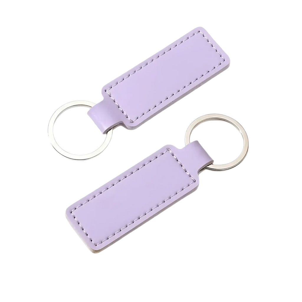 Customized leather keychain set featuring a lavender leather key fob with stitched edges and silver-toned metal ring