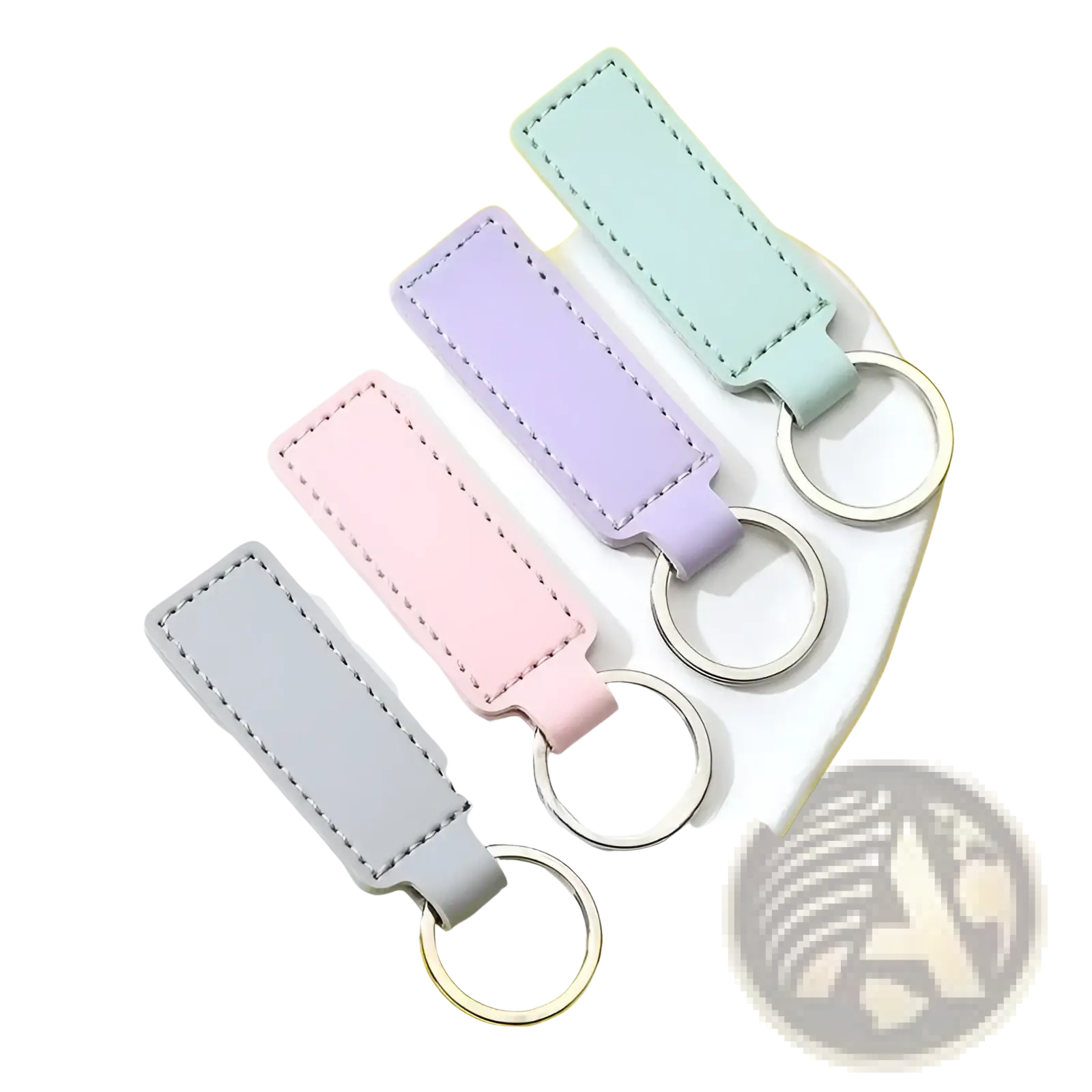 Customized leather keychain set featuring pastel-colored rectangular leather keychains with stitched edges and metallic rings