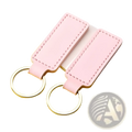 Pink rectangular leather keychains with silver toned metal rings in a customized leather keychain set