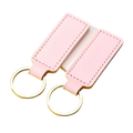 Pink rectangular leather keychains with silver toned metal rings in a customized leather keychain set