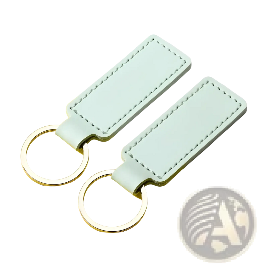 Two mint green customized leather keychains with silver-toned metal rings for personalized use
