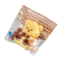 Yellow bear-shaped silicone squishy toy with brown and pink accents in clear bag for sensory fidget stress relief