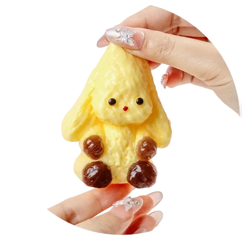 A yellow textured bunny-shaped squishy toy with black eyes red nose and four glossy brown feet for stress relief