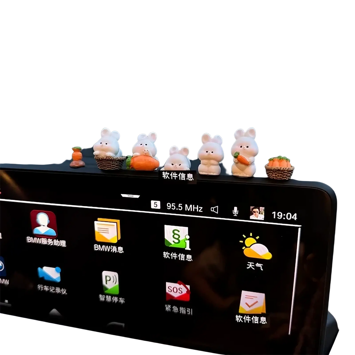 A row of five white cute bunny car dashboard ornaments with tiny baskets and carrots as decorations